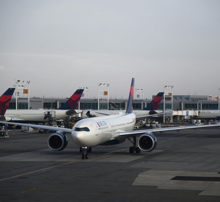 Delta Air Lines aircraft on the tarmac at Hartsfield-Jackson Atlanta International Airport (ATL) near terminal gates.