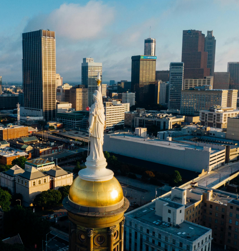 Georgia State Capitol’s gold dome with the Miss Freedom statue overlooking the Downtown Atlanta skyline.