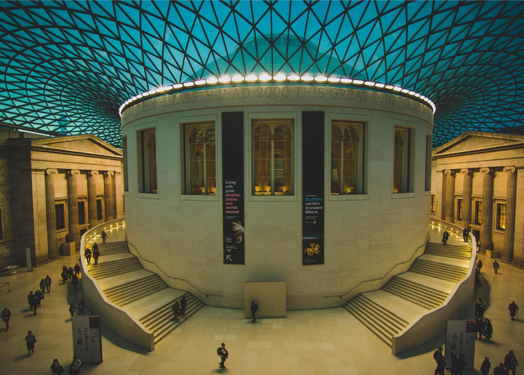 The British Museum’s Great Court with the circular Reading Room and glass lattice roof, London, UK.