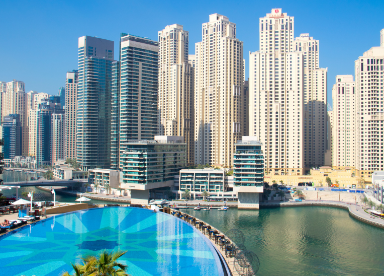 Daytime view of Dubai Marina skyscrapers with hotel pool overlooking the waterfront