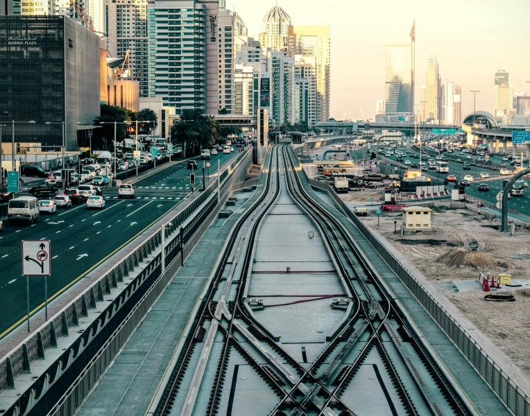 Dubai tram tracks along Sheikh Zayed Road with city skyline and traffic in the background.