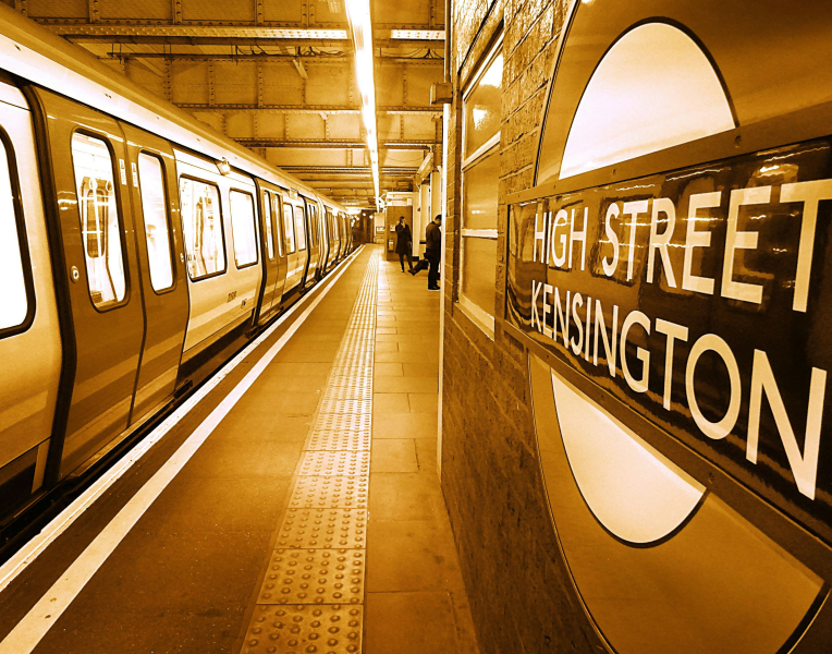 High Street Kensington London Underground station with a District line train at the platform.