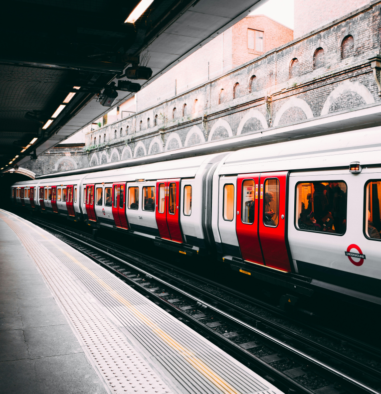 London Underground train at a station platform with red and white carriages in Central London.