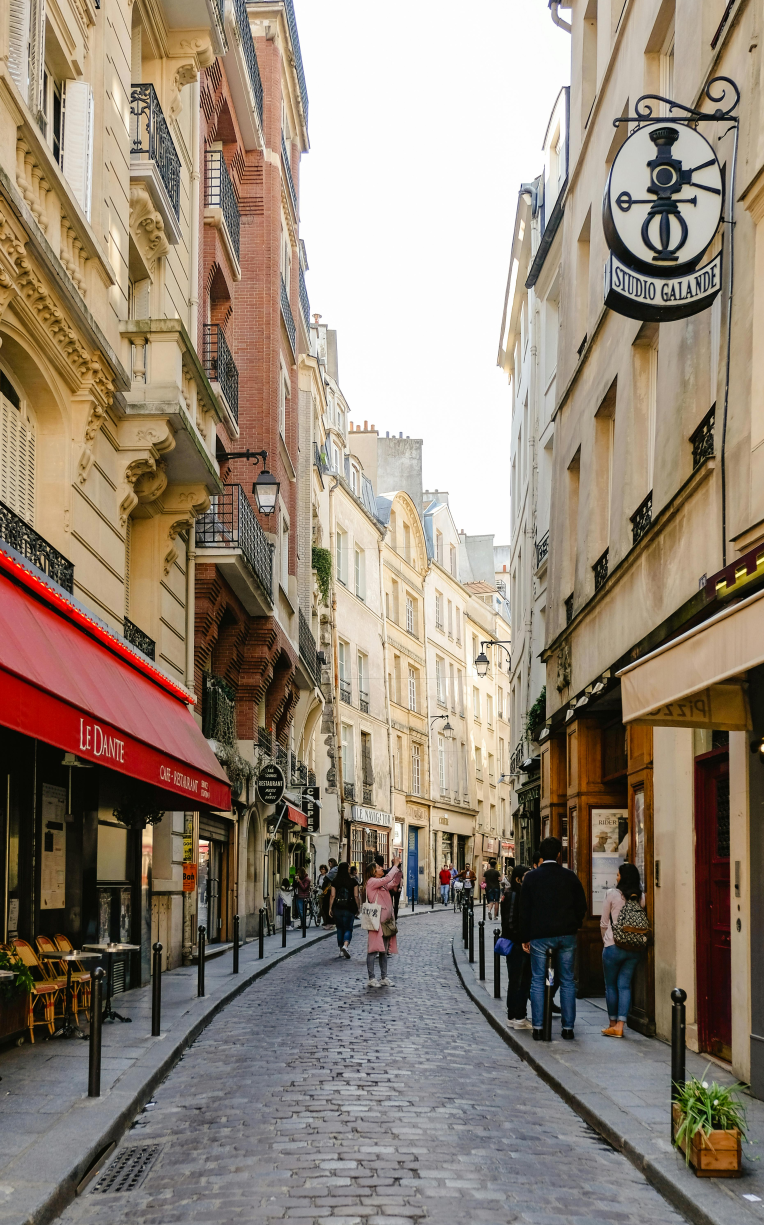 Cobbled street with cafés and shops in the Latin Quarter of Paris, France