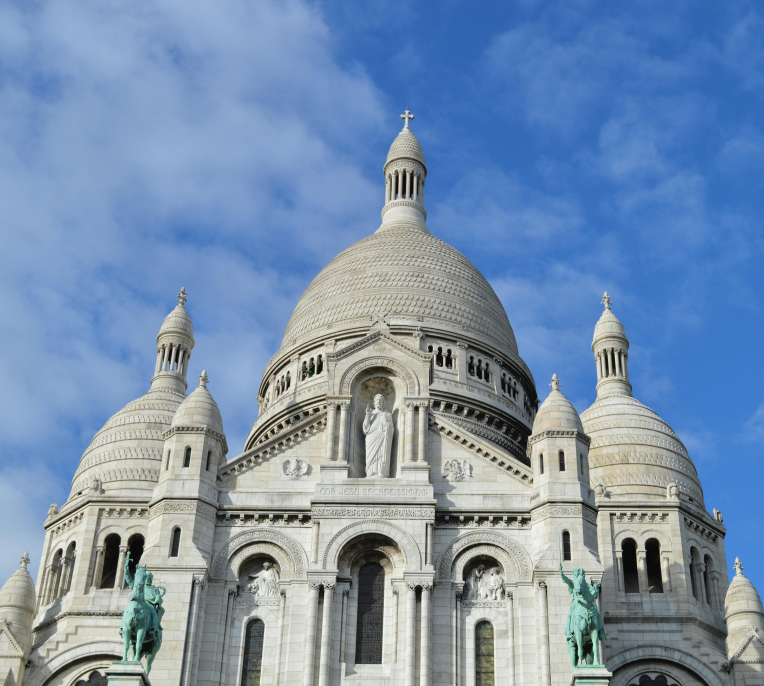 Sacré-Cœur Basilica in Montmartre, Paris, France, under a blue sky