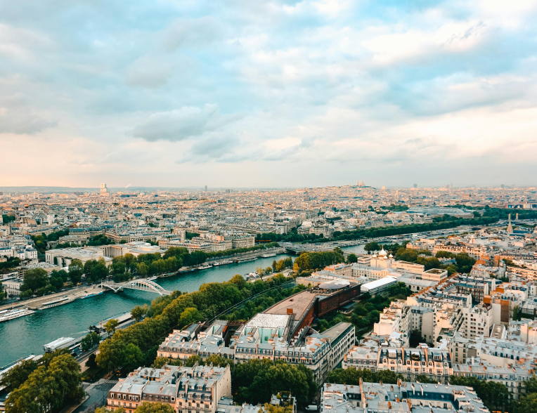 Aerial view of the Paris skyline with the Seine River and city rooftops