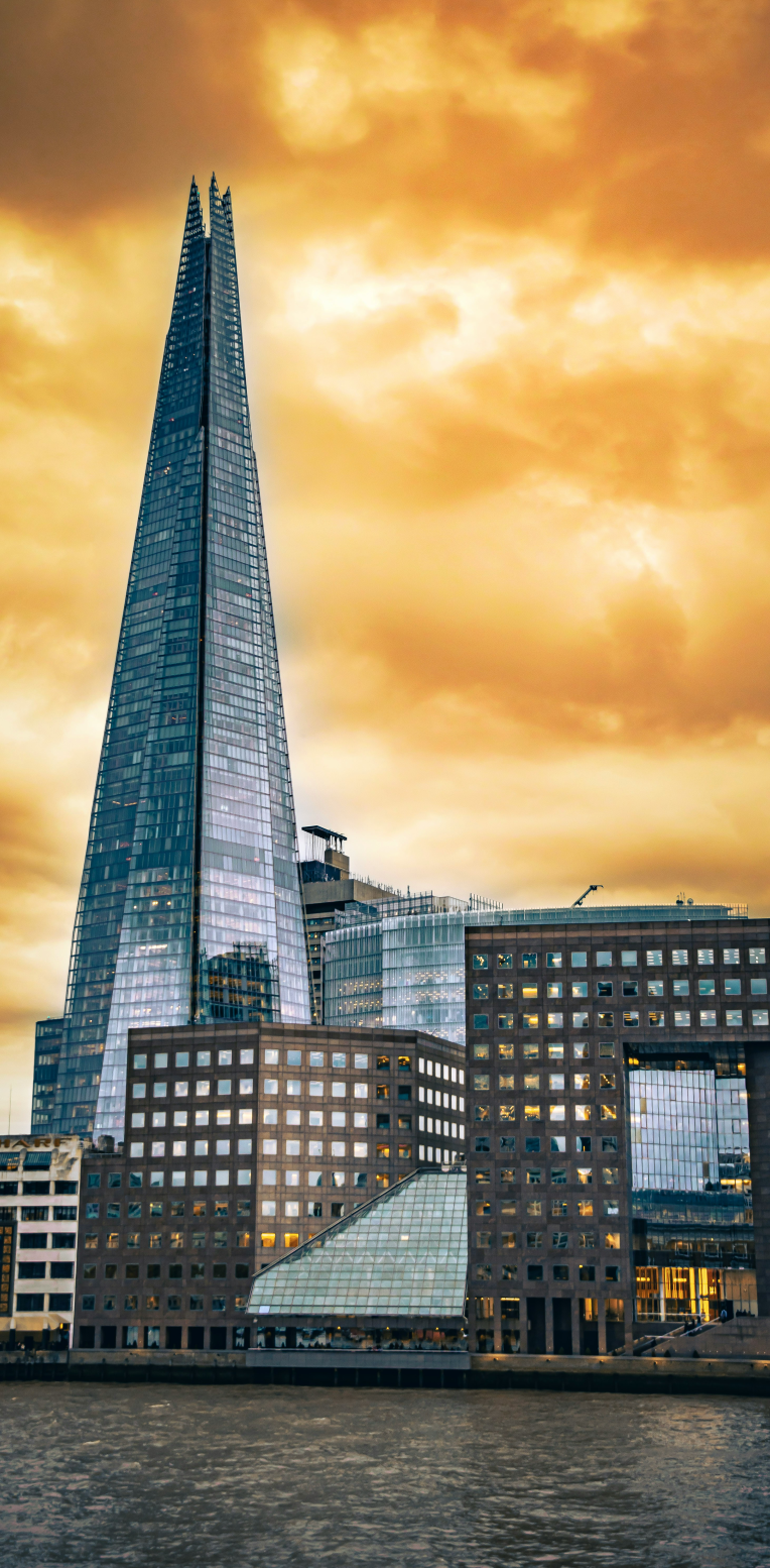 The Shard skyscraper on London’s South Bank rising above the River Thames at sunset.