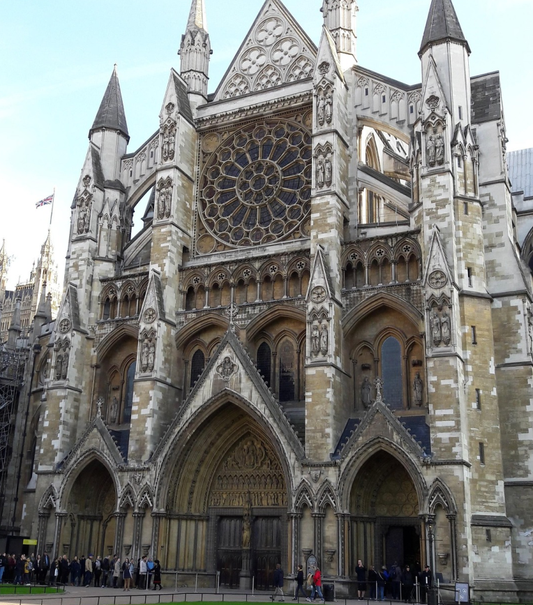 Westminster Abbey west façade with Gothic arches and rose window in Westminster, London, UK.