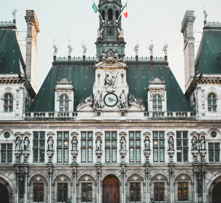 Facade of the Hôtel de Ville in Paris, France, featuring ornate stone architecture and clock tower.