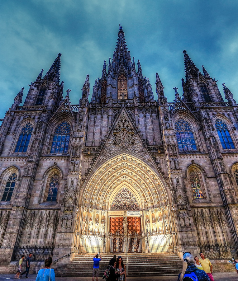 Barcelona Cathedral (Cathedral of the Holy Cross and Saint Eulalia) illuminated at night in the Gothic Quarter, showcasing its ornate Gothic facade and spires.