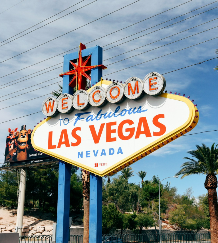 Welcome to Fabulous Las Vegas Nevada sign on Las Vegas Boulevard, featuring the iconic retro design with red star and palm trees in the background.
