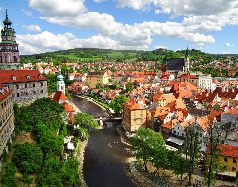 Panoramic view of Český Krumlov Old Town with red rooftops and the Vltava River winding through the historic centre, Czech Republic.