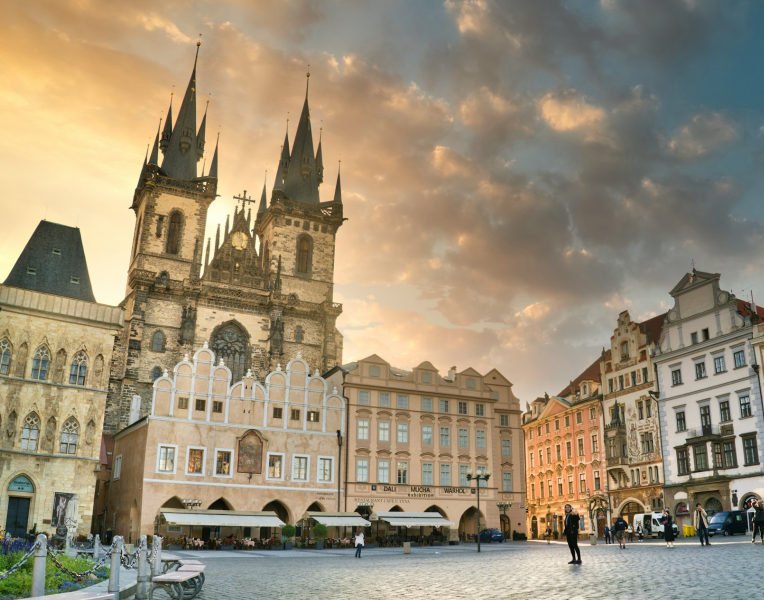 Old Town Square in Prague at sunset with the Church of Our Lady before Týn and colourful historic buildings, Czech Republic.