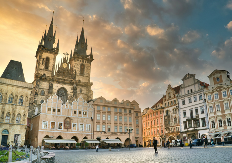 Old Town Square in Prague at sunset with the Church of Our Lady before Týn and colourful historic buildings, Czech Republic.