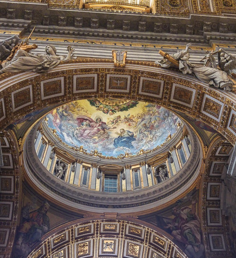 Interior of St Peter’s Basilica dome in Vatican City, Rome, featuring ornate gold details, statues, and colourful religious fresco artwork.